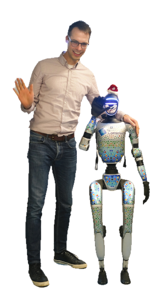 Florian Simroth shaking hands with a Unitree humanoid robot